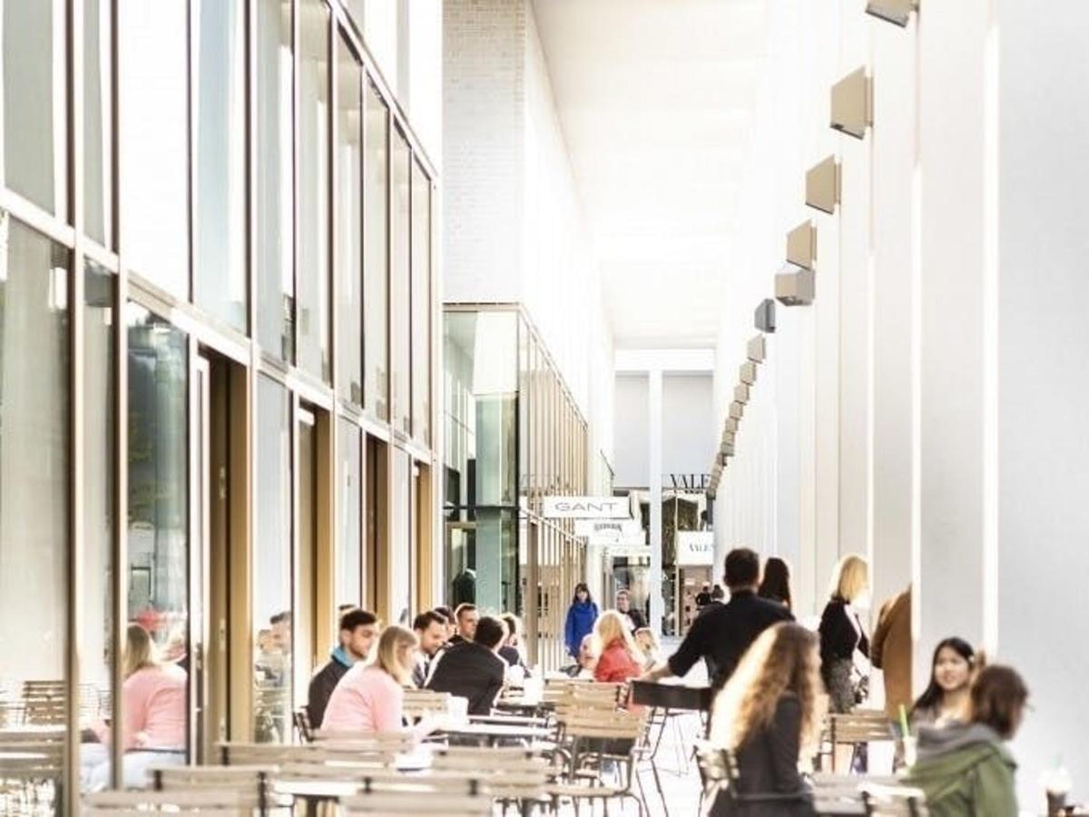a group of people sitting at tables in a building