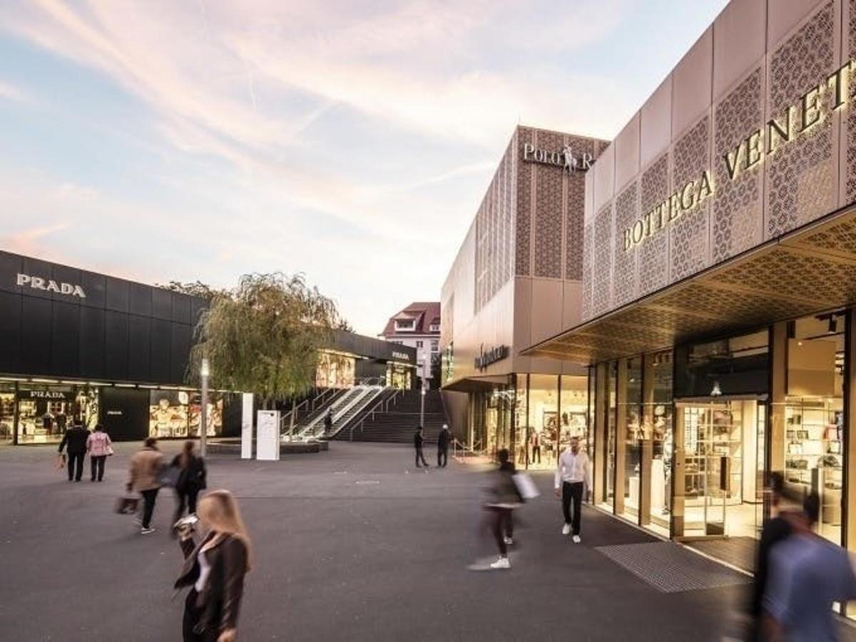 a rendering of a shopping mall with people walking around it