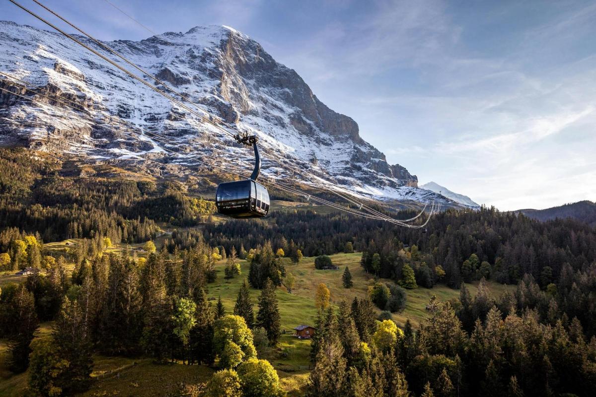 a gondola in front of a snow covered mountain