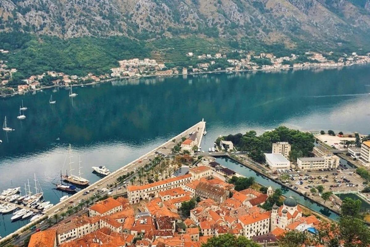 an aerial view of a town with boats in the water