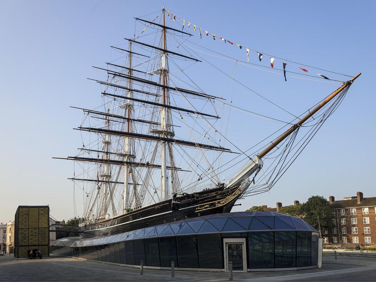 a tall ship is on display behind a building