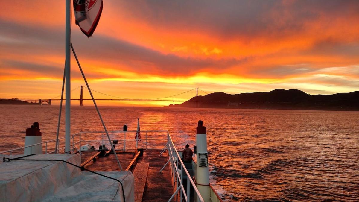 a boat on the water with a sunset