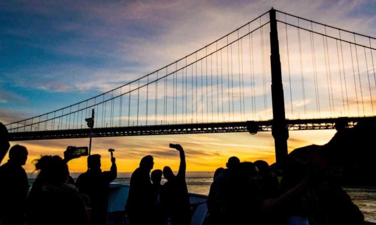 a group of people standing in front of a bridge