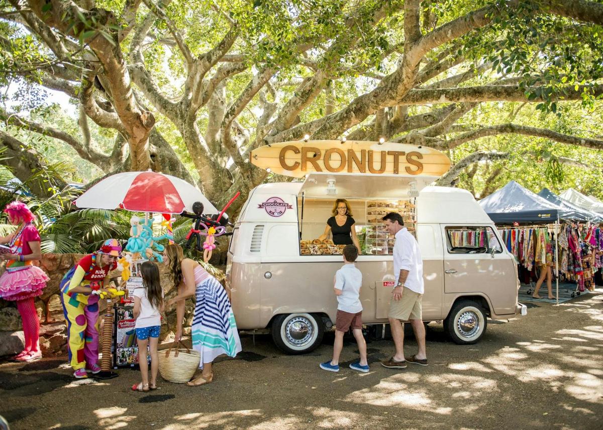 a group of people standing in front of a food truck