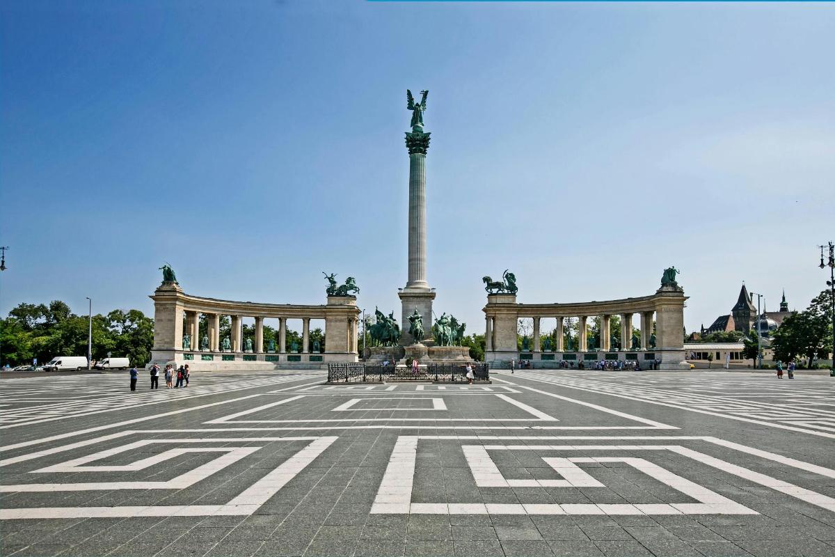 a large plaza with a monument in the background