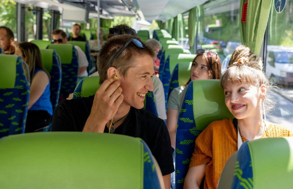 a man and a woman sitting on a bus