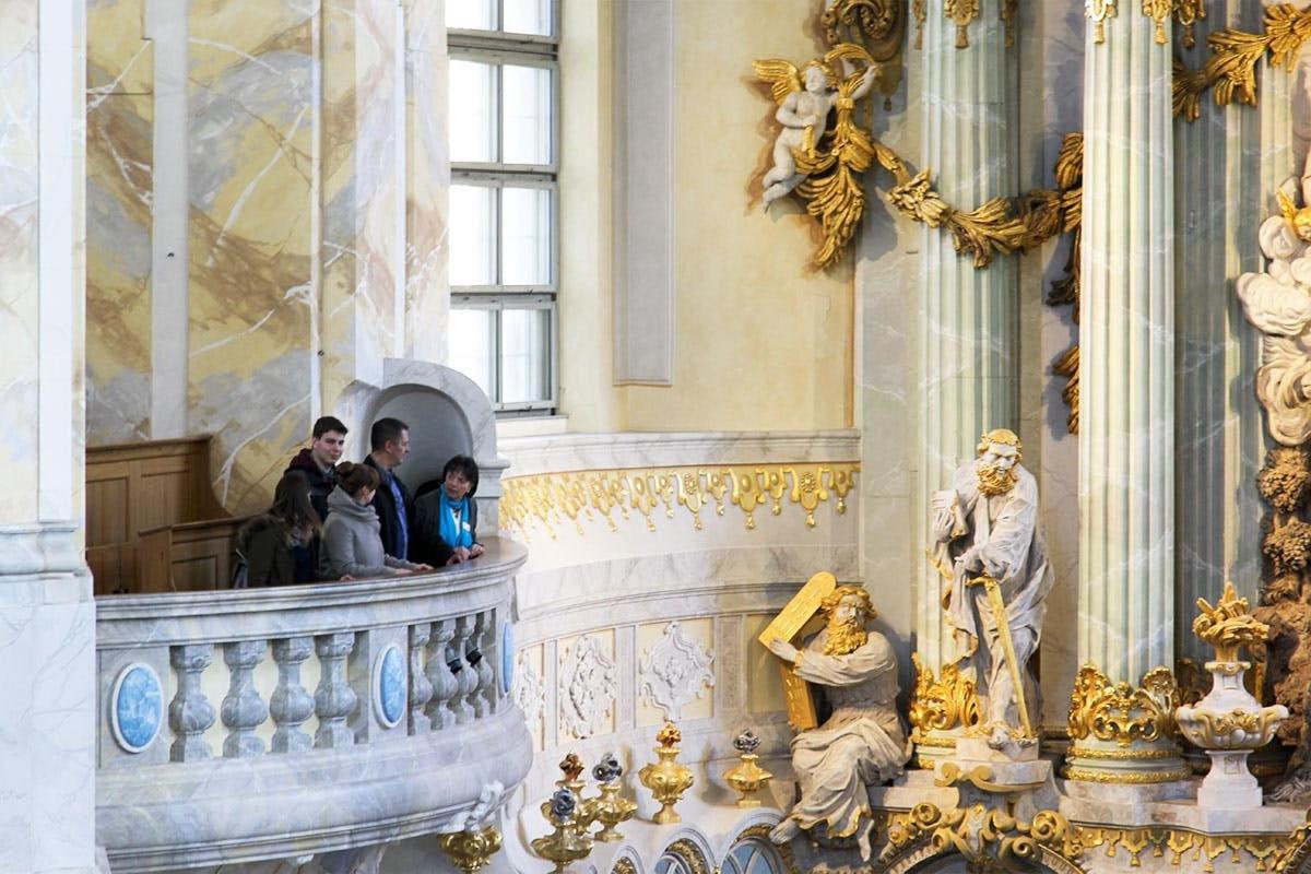 a group of people standing in a building with a statue