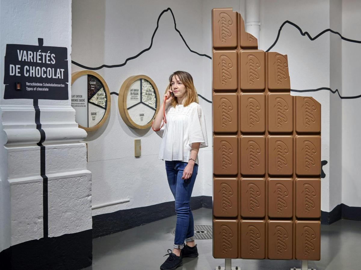 a woman standing in front of a large display of large bricks