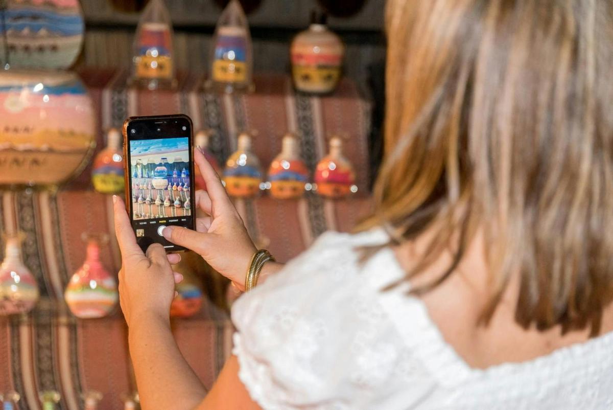 a woman taking a picture with her cell phone