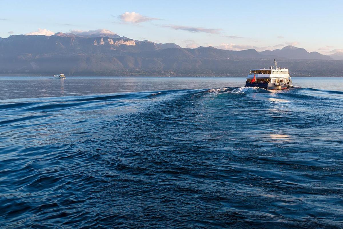a boat on the water with mountains in the background