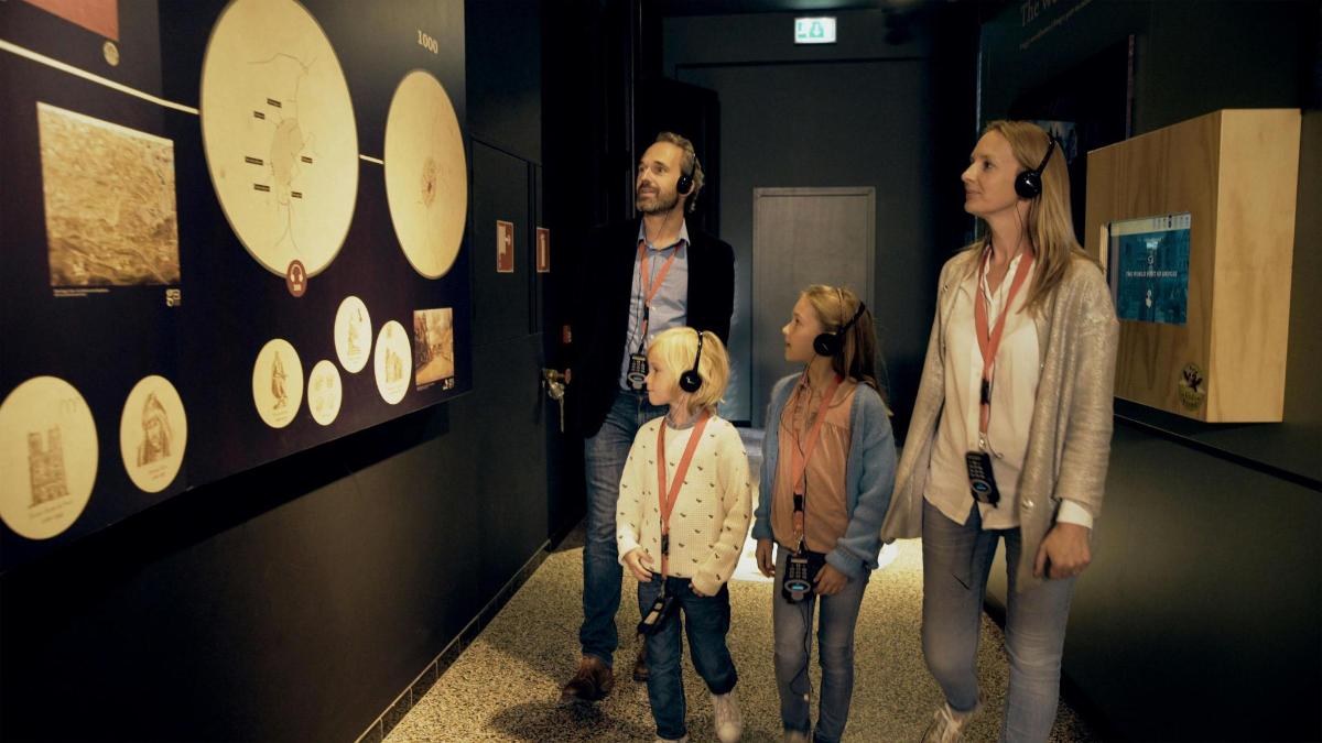 a family looking at a clock in a museum