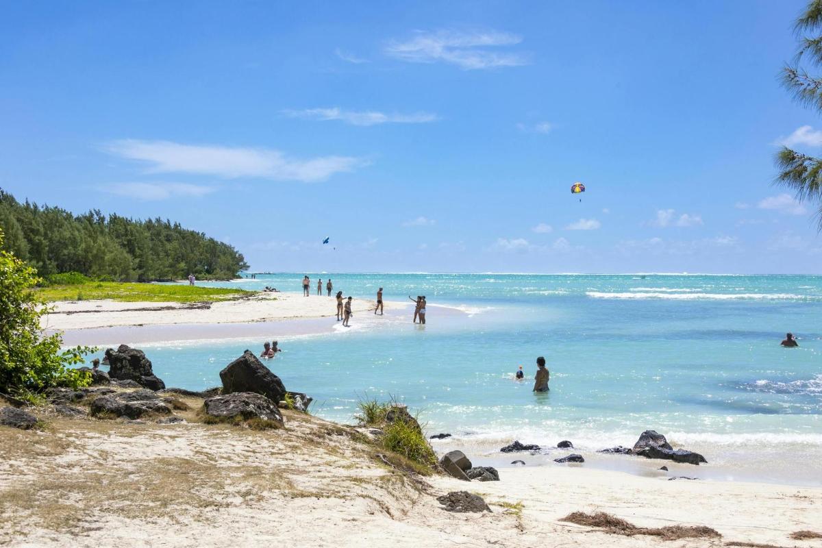 a group of people in the water at a beach