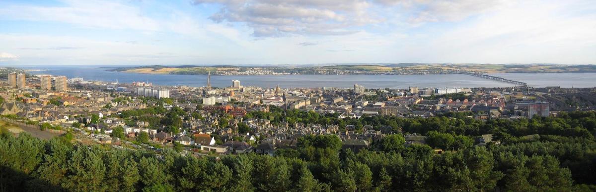 an aerial view of a city with a river and buildings