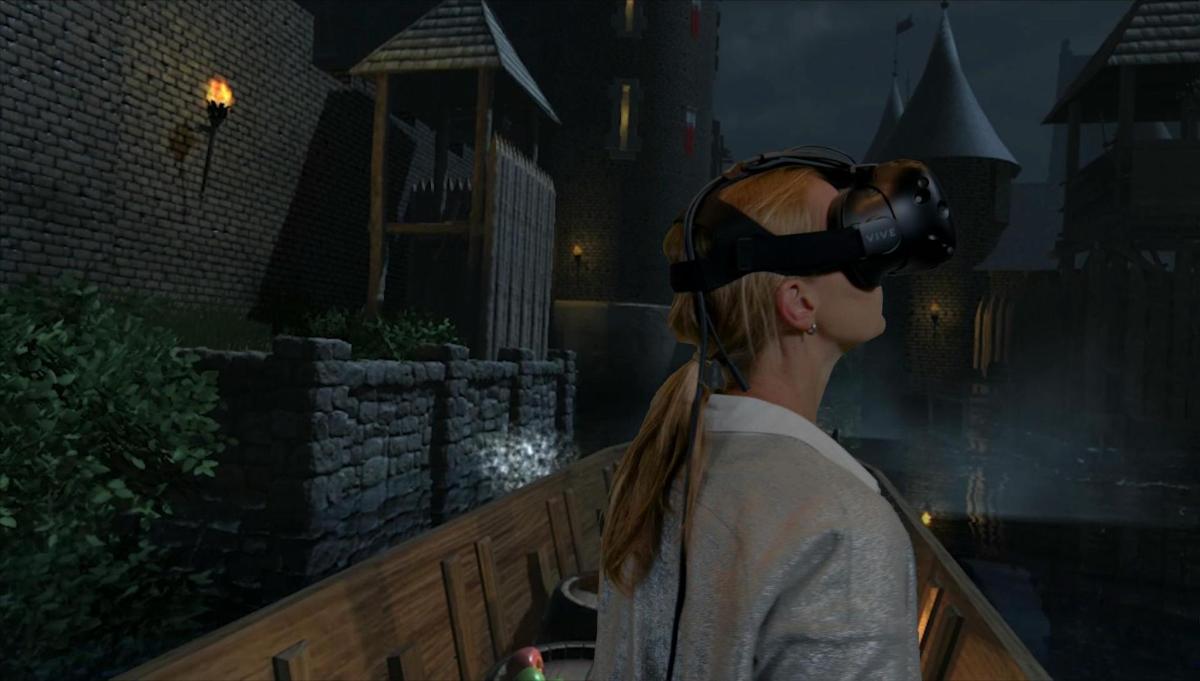 a woman wearing virtual reality glasses on a balcony