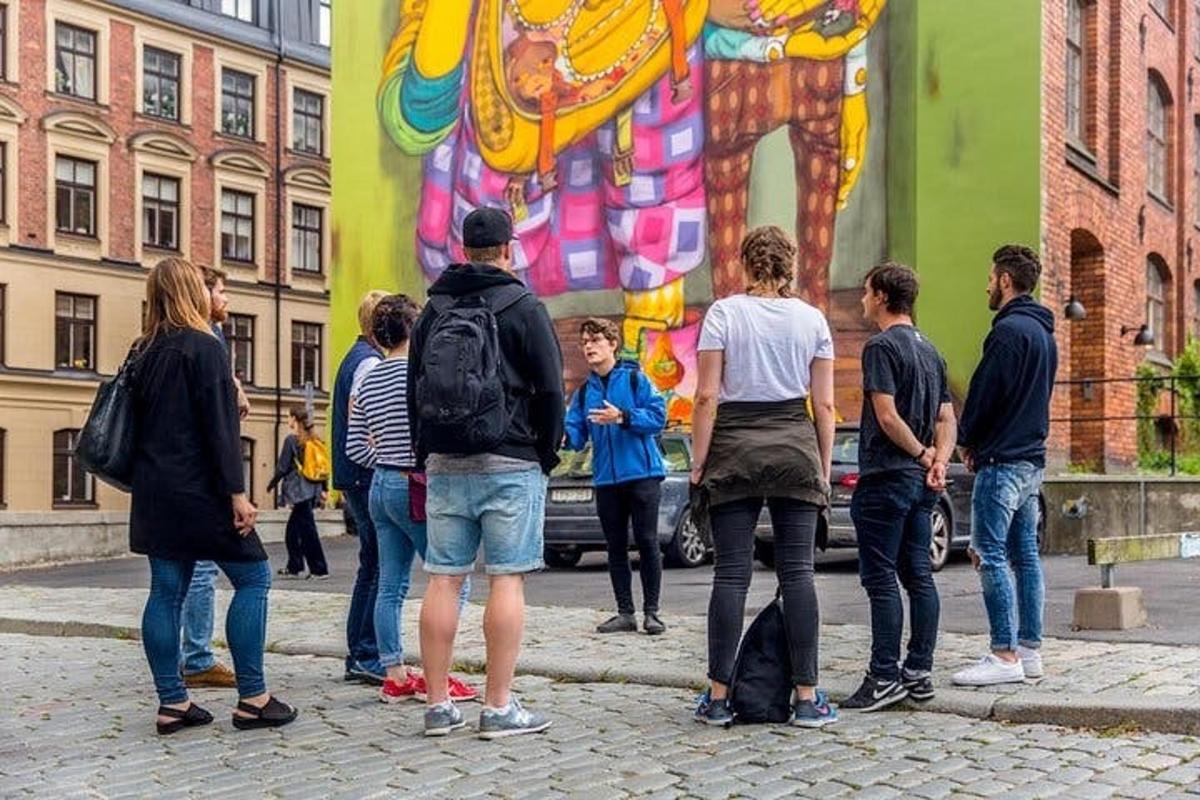 a group of people standing in front of a mural