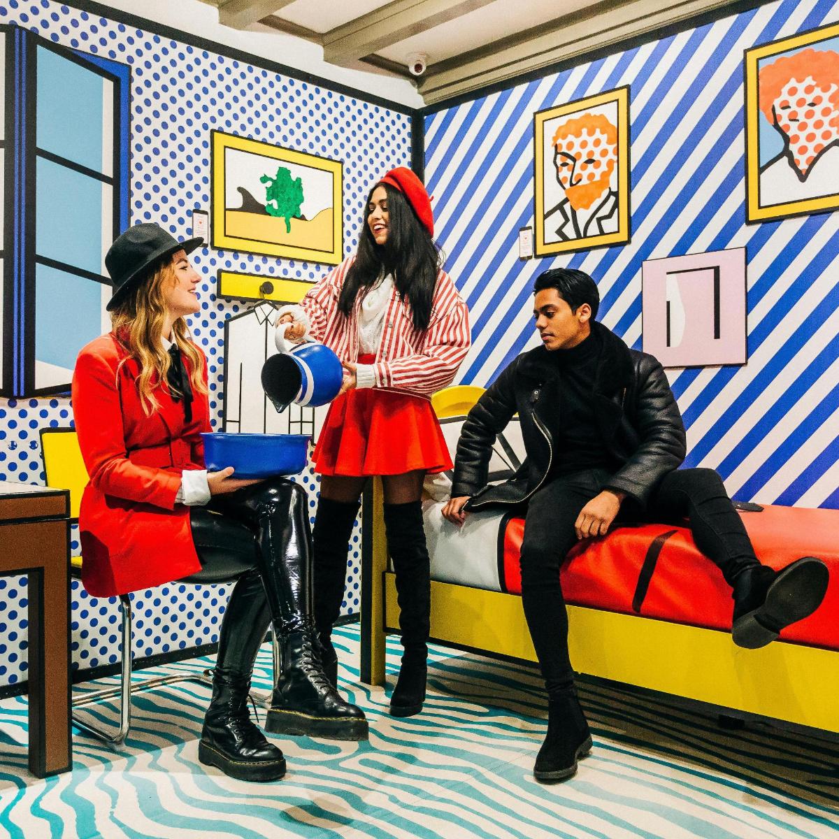 a group of three people sitting in a room