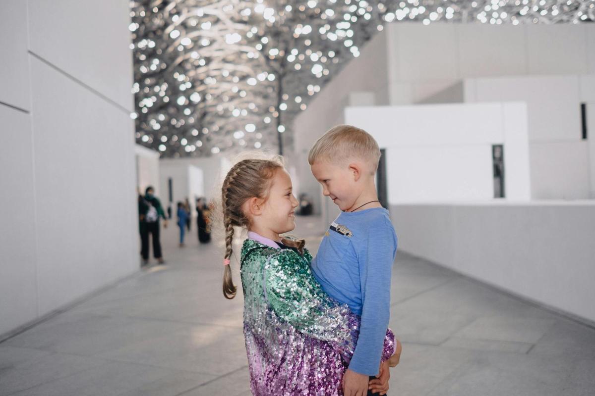 a boy and a girl standing in a room