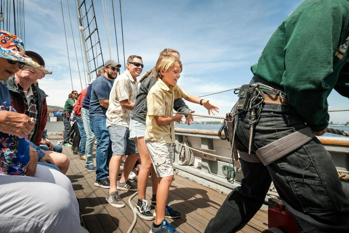 a group of people standing on a boat