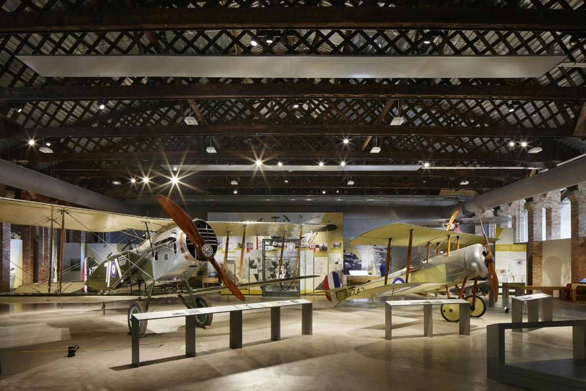 a museum with a plane and airplanes on display