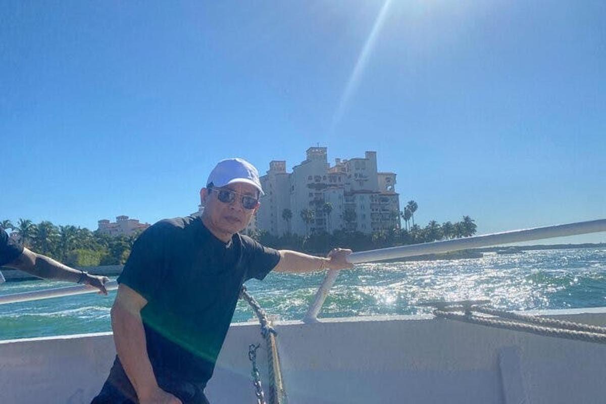 a man sitting on a boat in the water