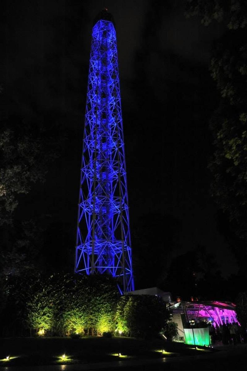 a blue tower is lit up at night