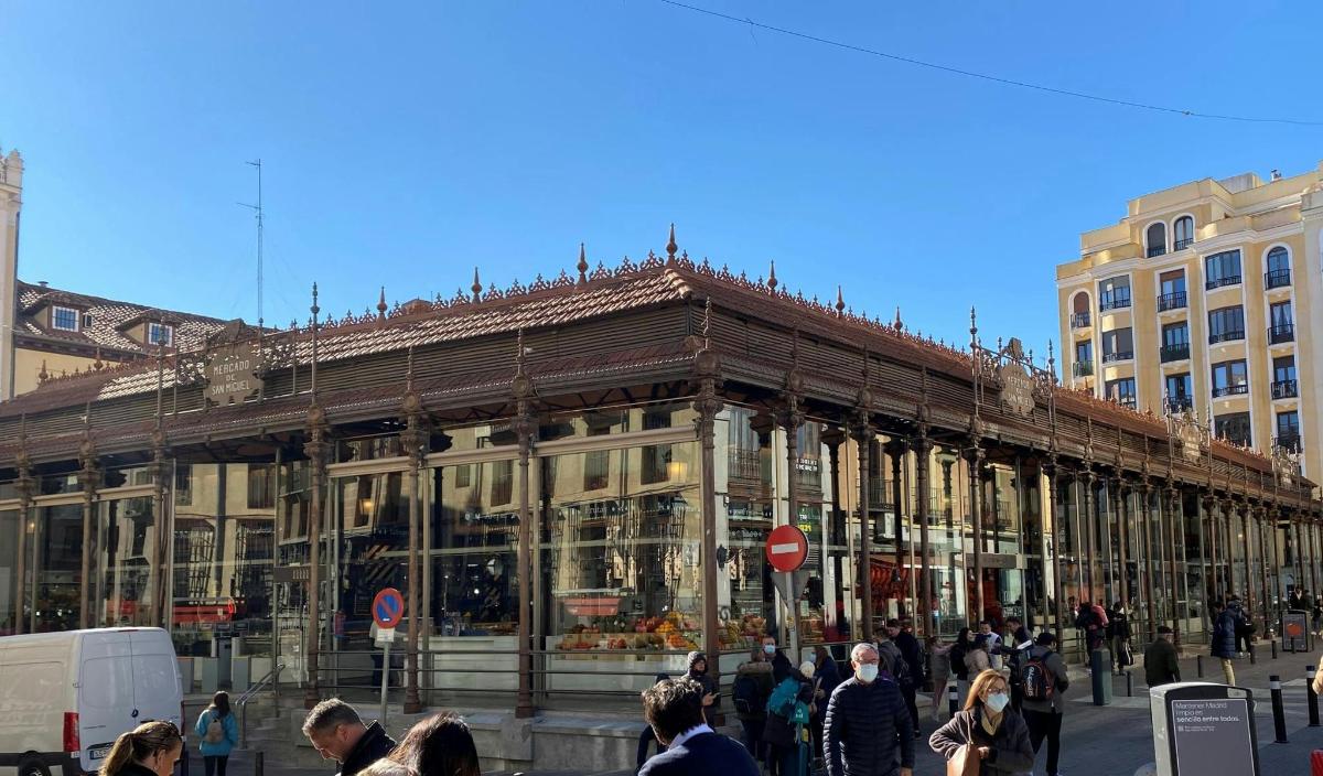 a large building with people walking in front of it