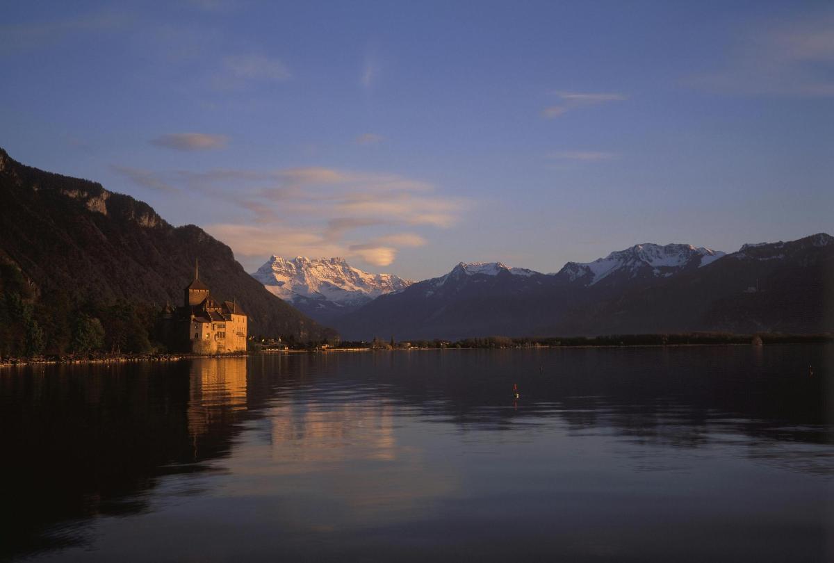 a large body of water with a castle and mountains