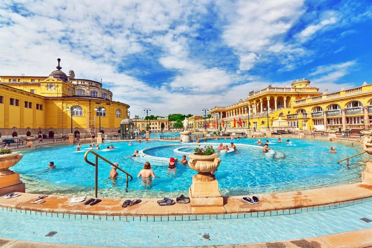 a large swimming pool in a building with people in it