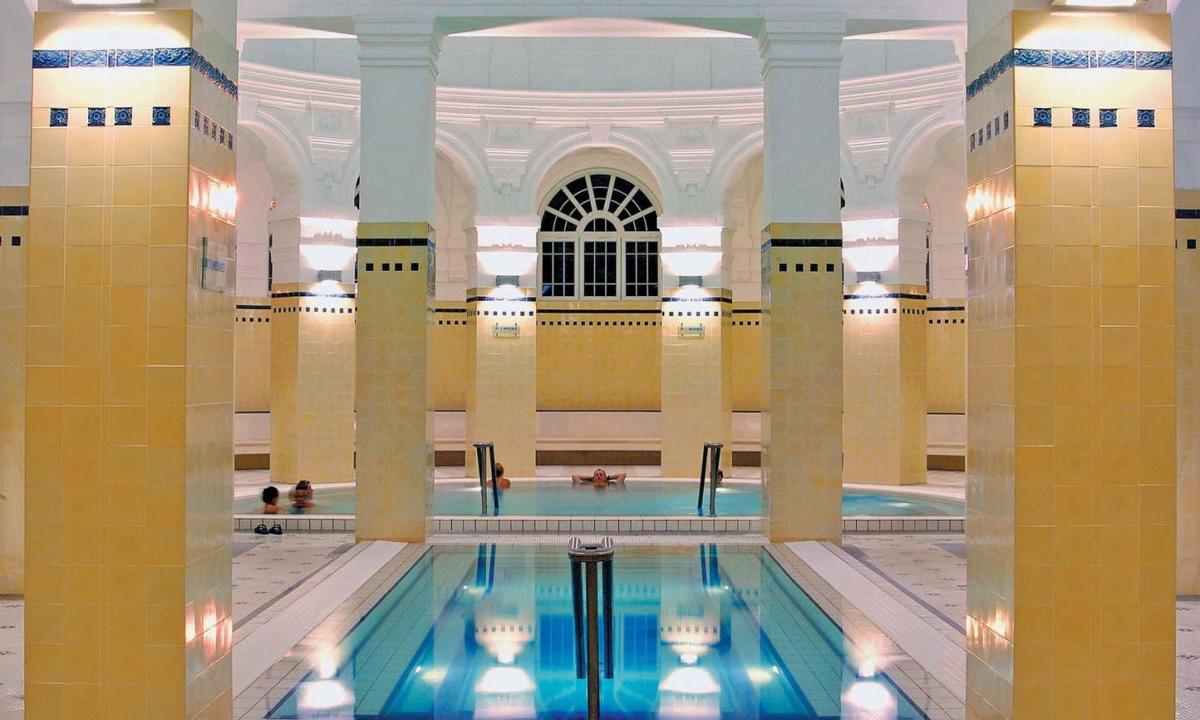 a swimming pool in a large building with a large building