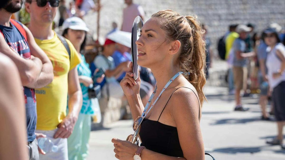 a woman holding an umbrella in a crowd of people