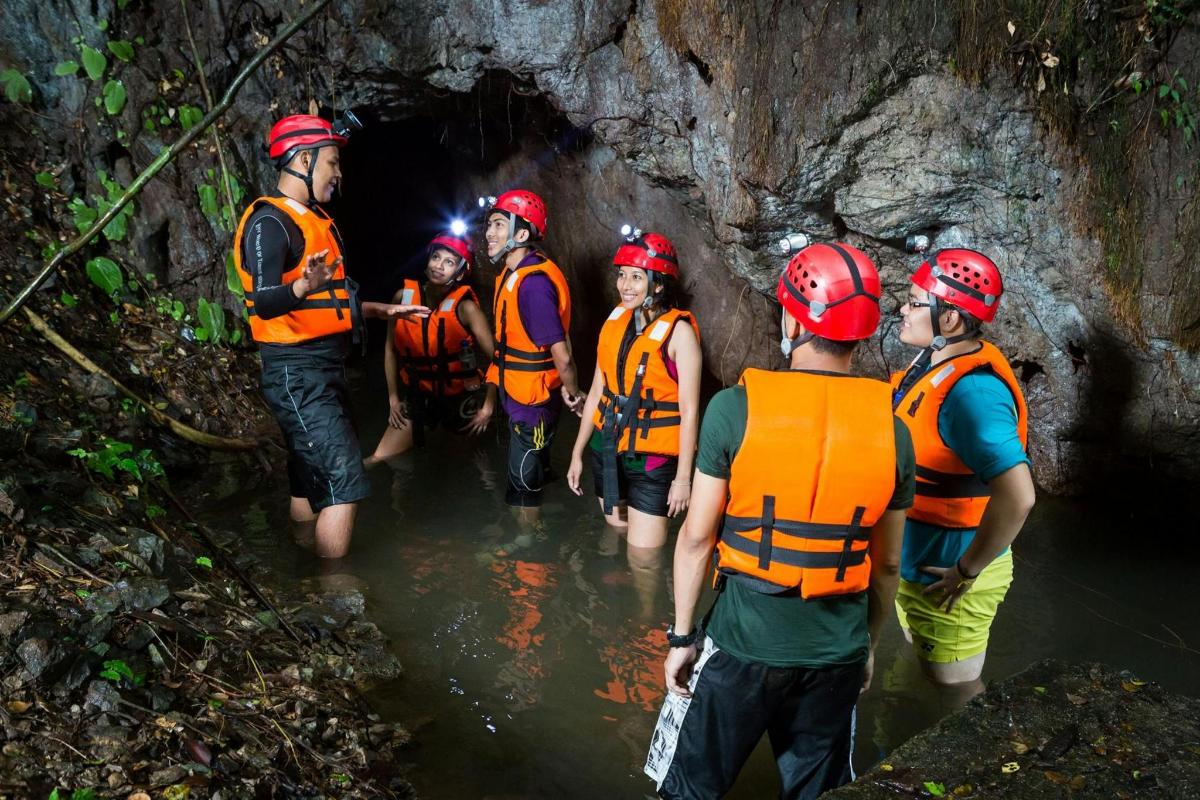 a group of people walking through a cave