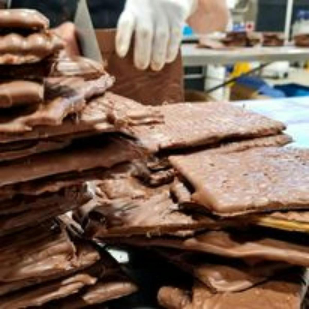 a pile of food with a hand in a white glove