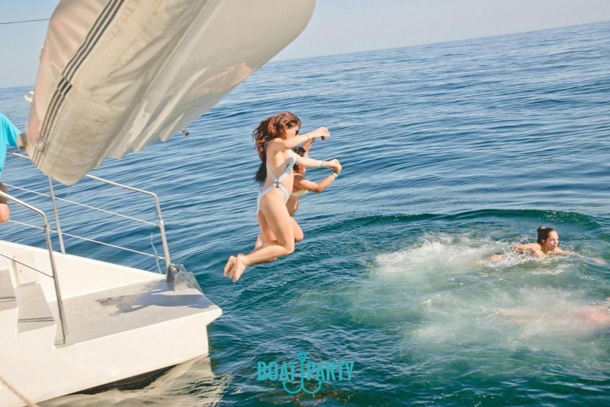 a woman jumping into the water from a boat