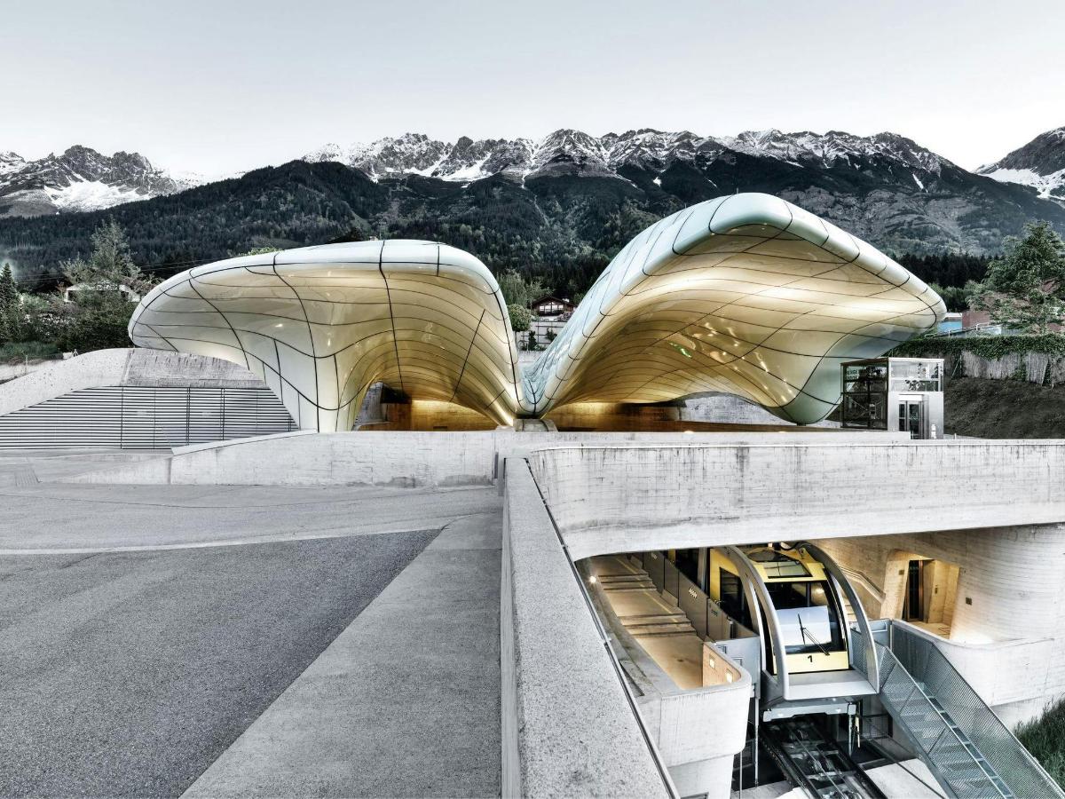 a rendering of a building with mountains in the background