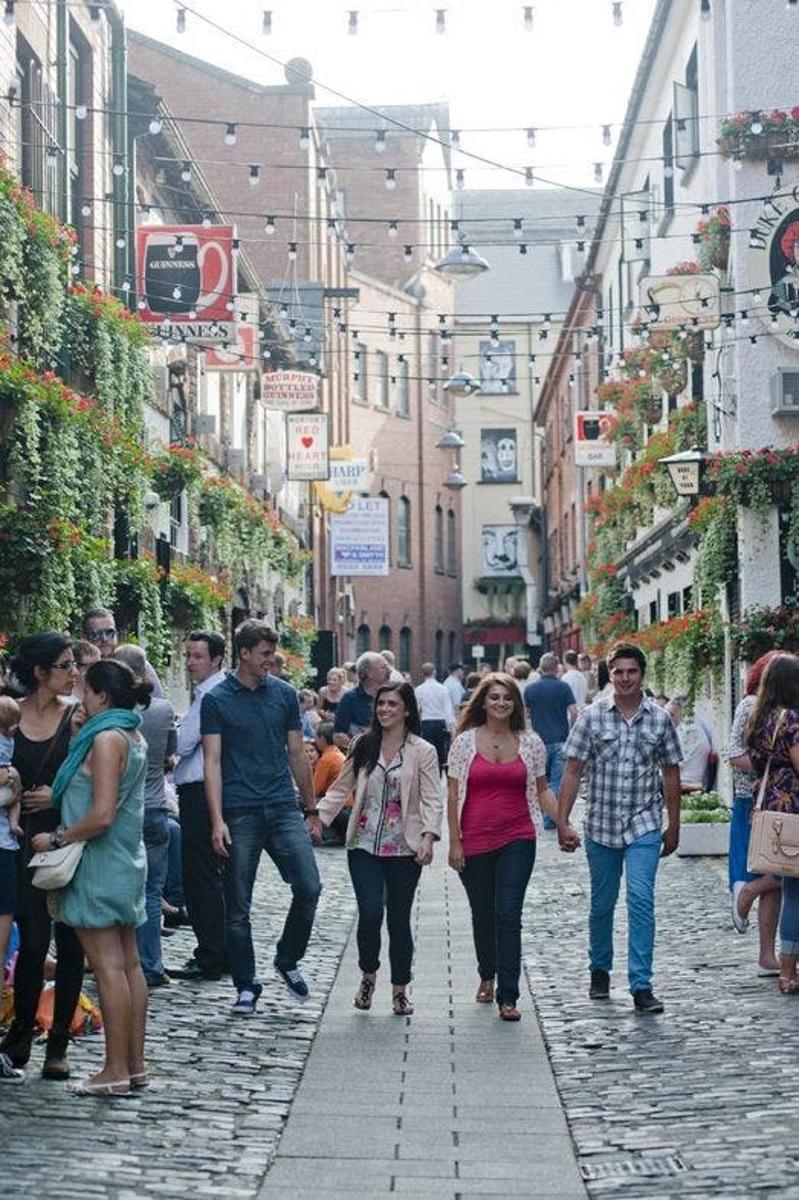 a group of people walking down a street