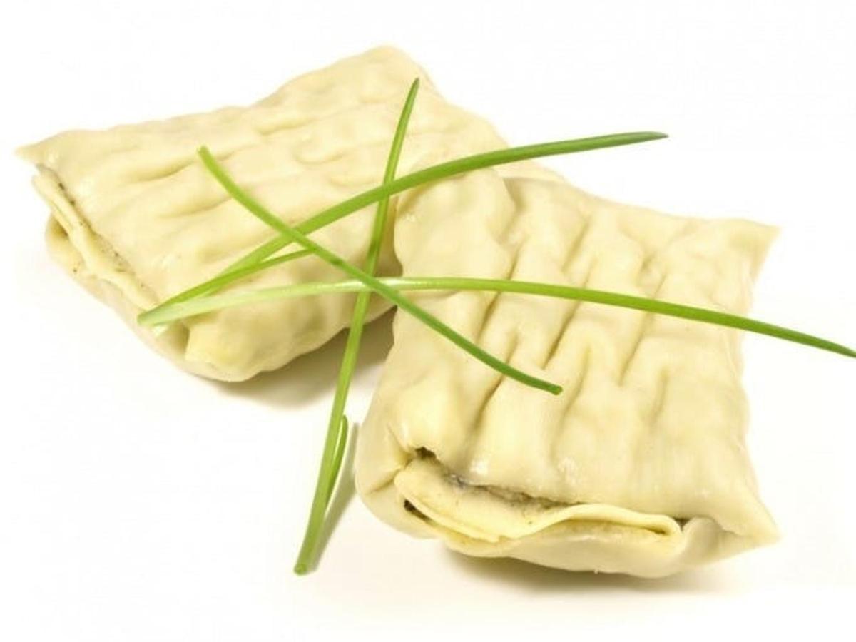 a piece of food with a green plant on it