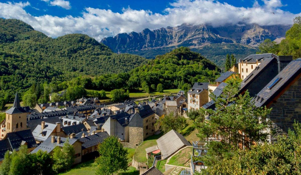an old town with mountains in the background