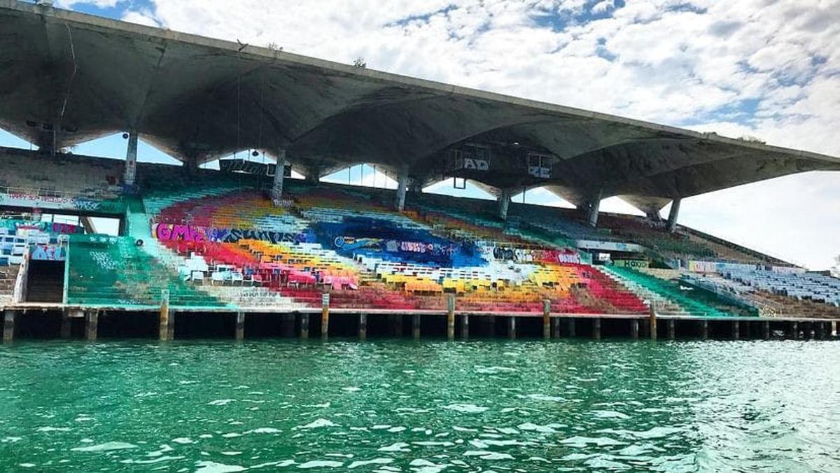 Un estadio con una pintura al lado del agua.