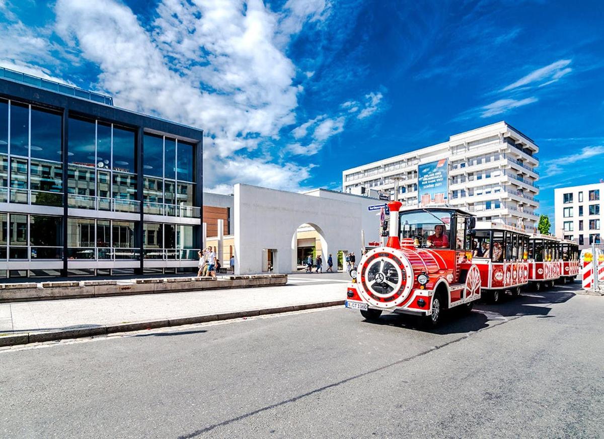 an old red fire truck driving down the street