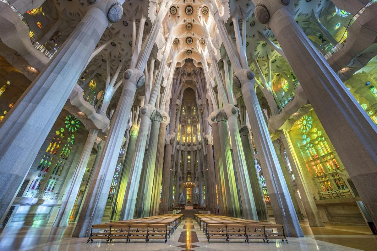 a cathedral with benches and stained glass windows