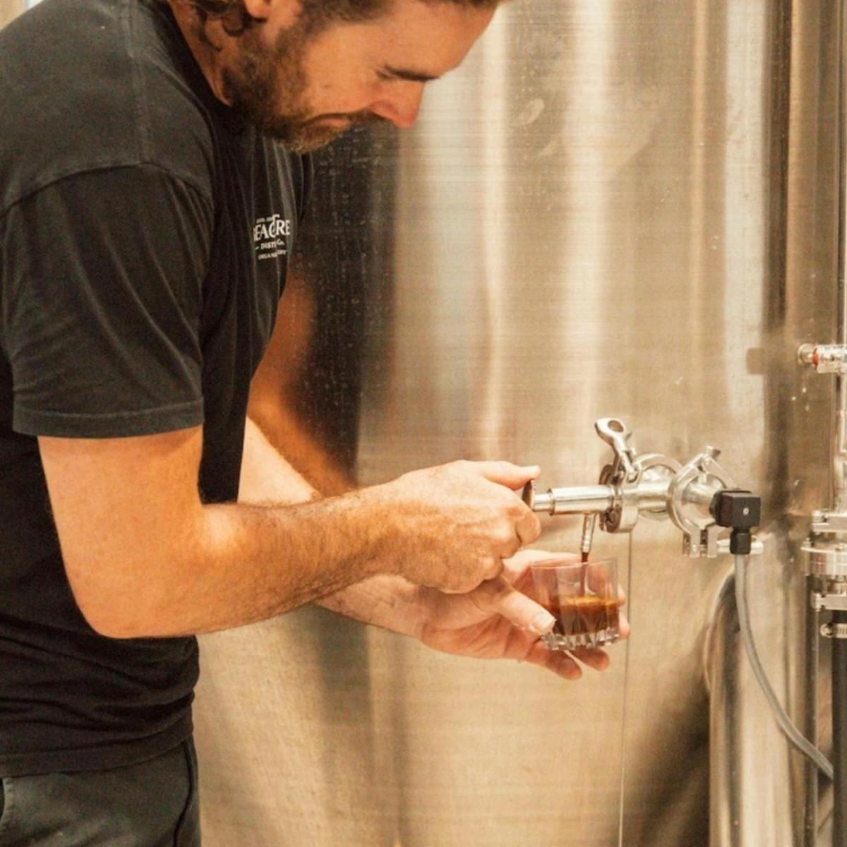a man is using a faucet in a bathroom