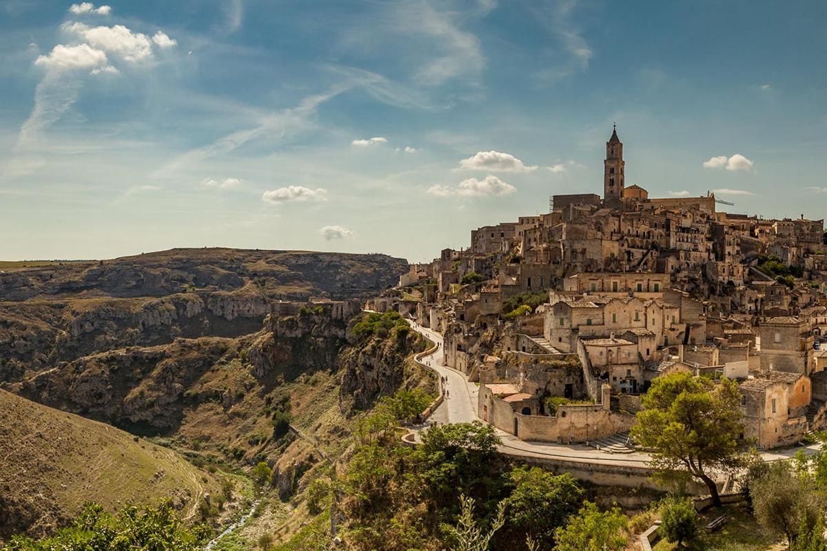 a town on top of a mountain with a road