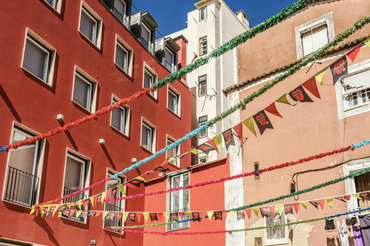 a building with colorful flags hanging from it