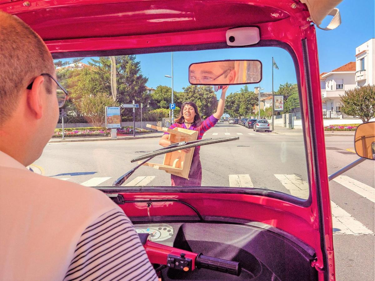 eine Frau winkt aus der Frontscheibe eines Busses