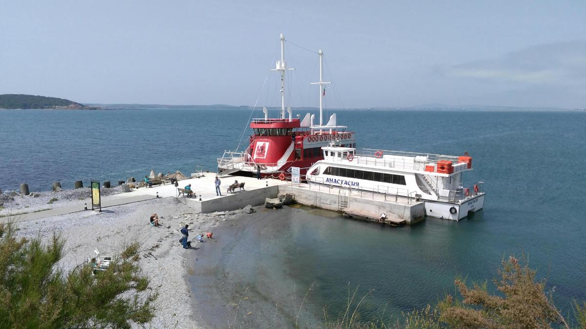 a red and white boat docked in the water