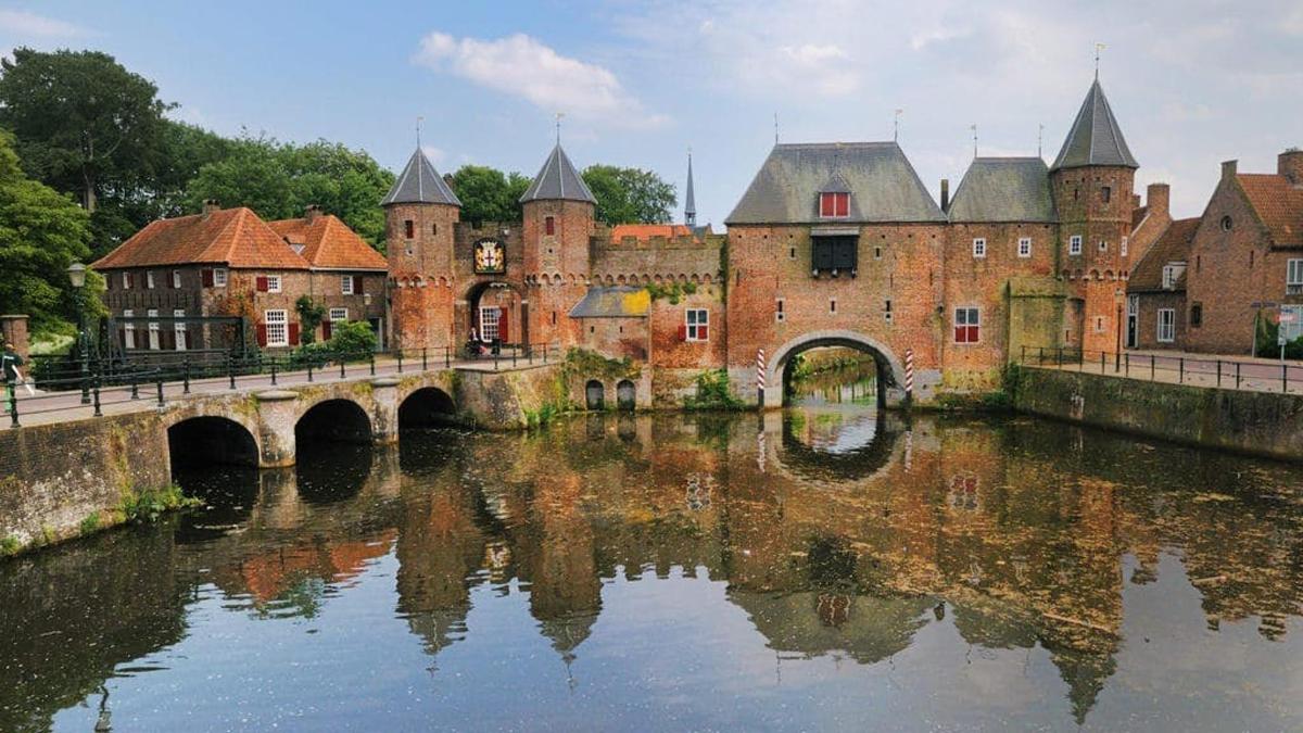 an old castle with a bridge over a river