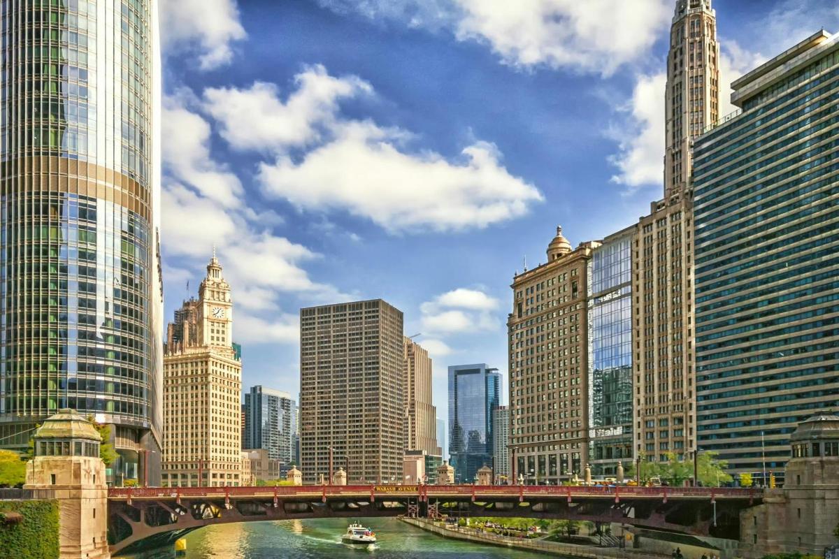 a bridge over a river in a city with tall buildings
