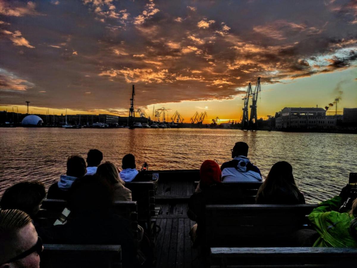 a group of people sitting on a boat in the water