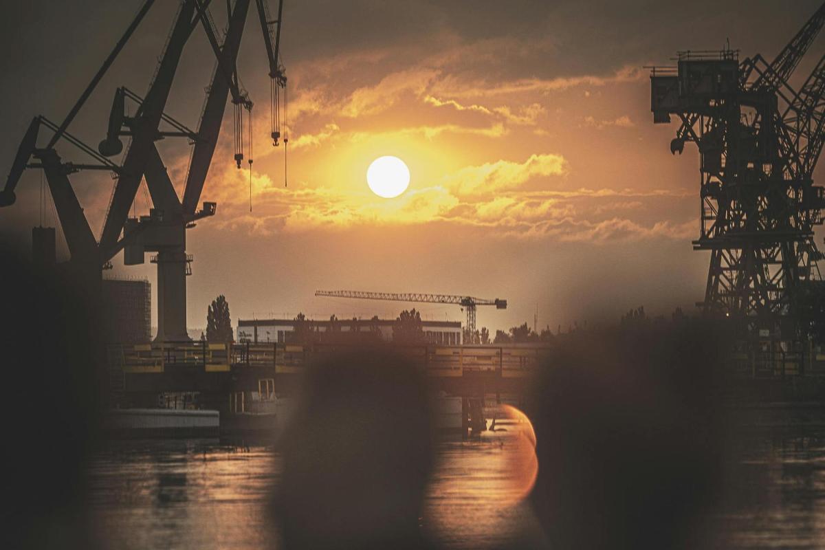a sunset over a river with the sun in the sky
