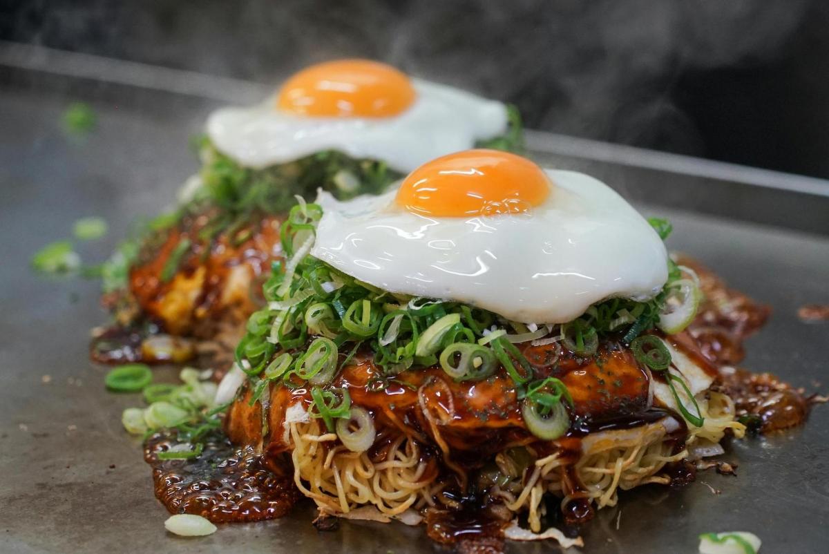 a plate of food with eggs on top of noodles